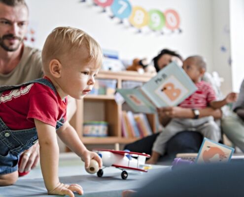 Little Boy Playing In A Classroom