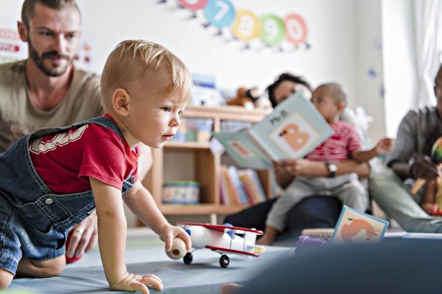 Little Boy Playing In A Classroom