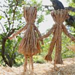 Male And Female Dolls Made From Straw In Garden