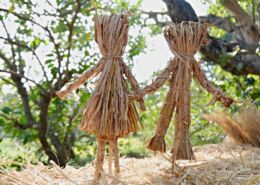 Male And Female Dolls Made From Straw In Garden