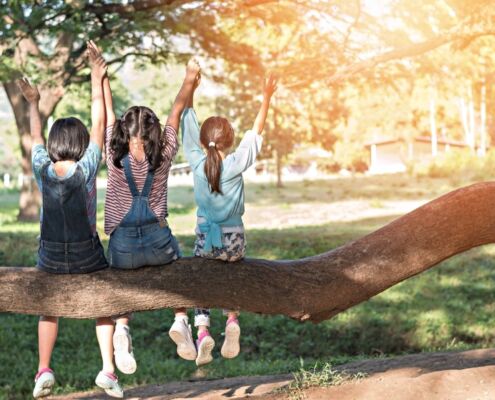 Children Friendship Concept With Happy Girl Kids In The Park Having Fun Sitting Under Tree Playing Together Enjoying Good Memory And Moment Of Student Friend Lifestyle In School Summer Time Day