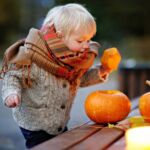 Toddler Playing With Halloween Pumpkins
