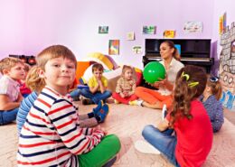 Kids And Teacher Sit In Circle