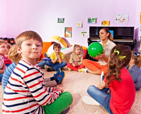 Kids And Teacher Sit In Circle