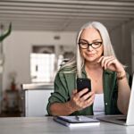 Stylish Senior Woman Messaging With Phone