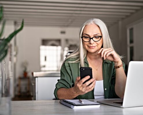 Stylish Senior Woman Messaging With Phone