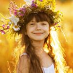 Happy Cute Girl Wearing A Wreath Of Flowers