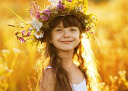 Happy Cute Girl Wearing A Wreath Of Flowers