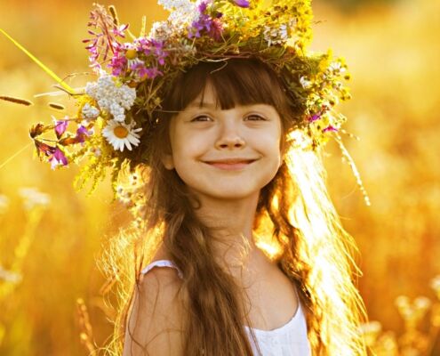 Happy Cute Girl Wearing A Wreath Of Flowers