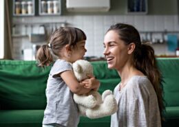 Smiling Young Mum Talking With Little Daughter