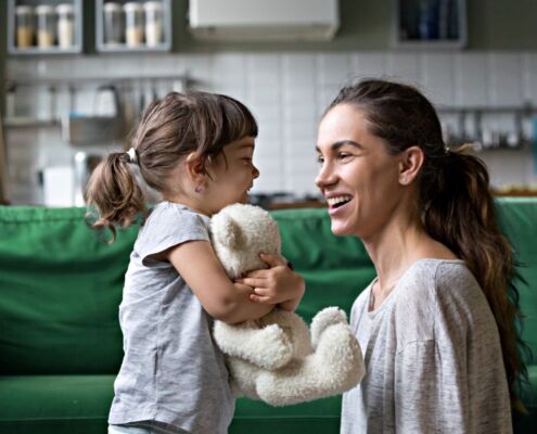 Smiling Young Mum Talking With Little Daughter