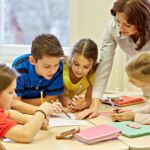 Group Of School Kids Writing Test In Classroom