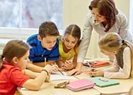 Group Of School Kids Writing Test In Classroom